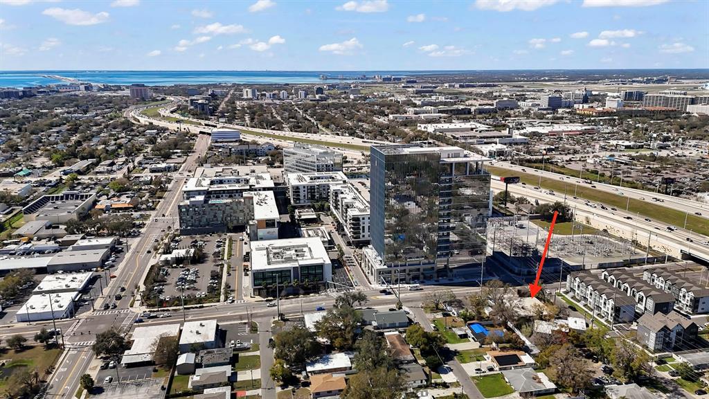 An aerial view shows a residential property marked with a red arrow near a high-rise — 1207 N HIMES AVENUE UNIT 2, TAMPA, FL
