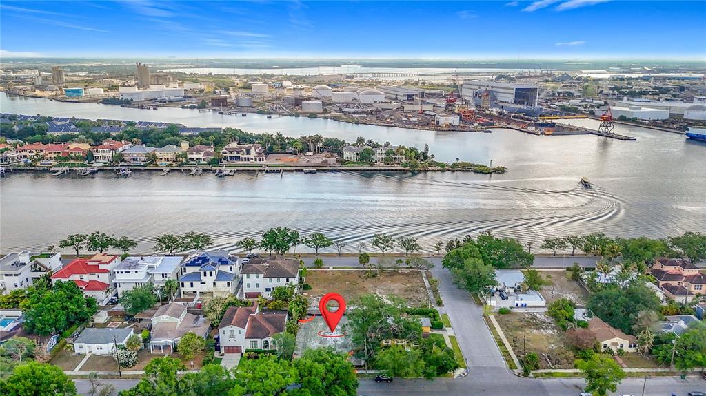 An aerial view shows a vacant residential lot marked with a pin near a waterway — 329 COLUMBIA DRIVE, TAMPA, FL
