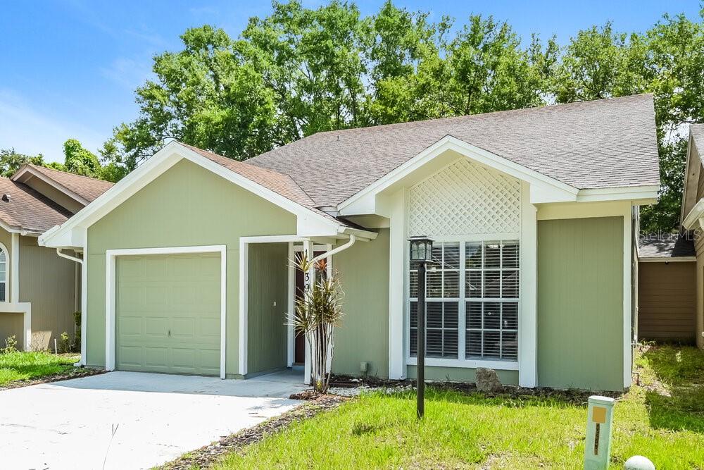 A single-story house with green siding, a one-car garage, and a front-facing window — 1839 BLAINE TERRACE, WINTER PARK, FL