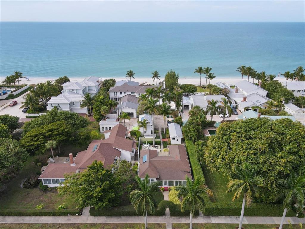 An aerial view of a coastal neighborhood featuring houses with brown roofs near the beach — 241 GILCHRIST AVENUE UNIT F, BOCA GRANDE, FL