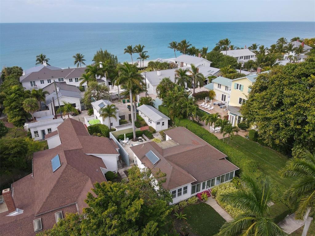 An aerial view shows several coastal houses with brown roofs surrounded by lush tropical trees — 241 GILCHRIST AVENUE UNIT F, BOCA GRANDE, FL