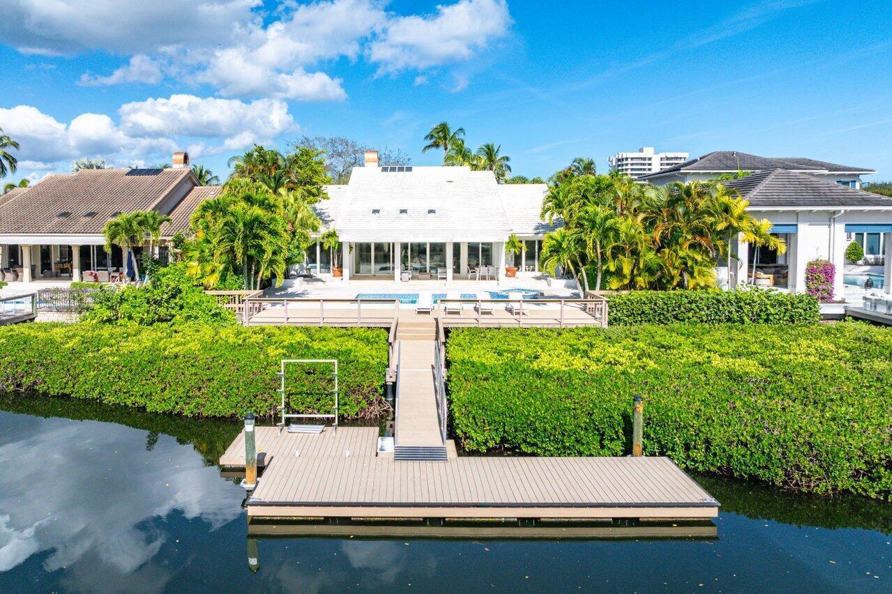 An aerial view of a waterfront house with a private dock and a swimming pool — 215 Island Drive, Jupiter FL 33477, JUPITER, FL