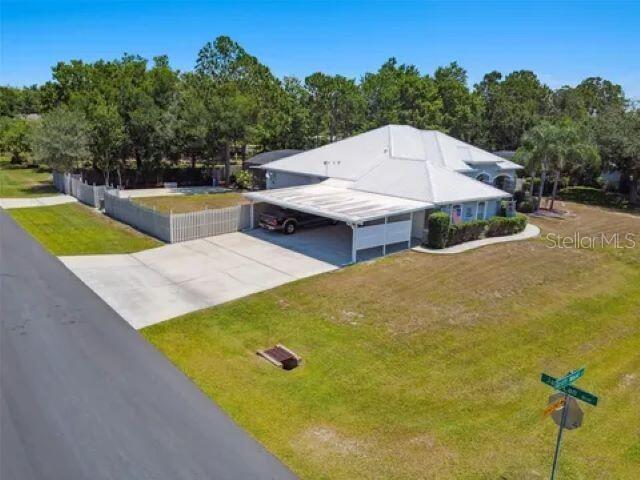 An aerial view of a single-story house with a white roof and a carport — 1900 GRIFF WOOD COURT, ST CLOUD, FL