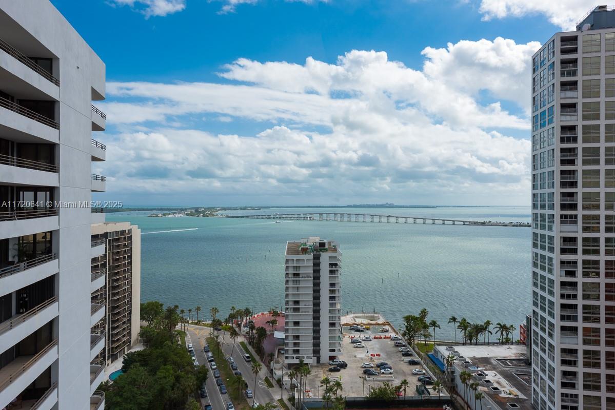 An elevated view shows a bay, a long bridge, and surrounding high-rise apartment buildings — 1451 Brickell Ave # 2103, Miami FL 33131, MIAMI, FL