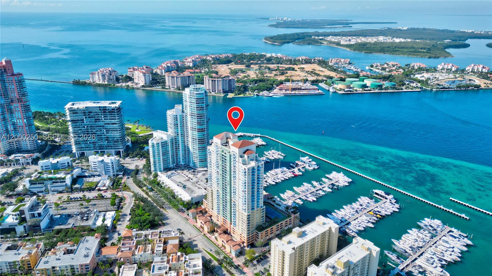An aerial view shows a high-rise residential building with a red roof near a marina — 90 Alton Rd # 2010, Miami Beach FL 33139, MIAMI BEACH, FL