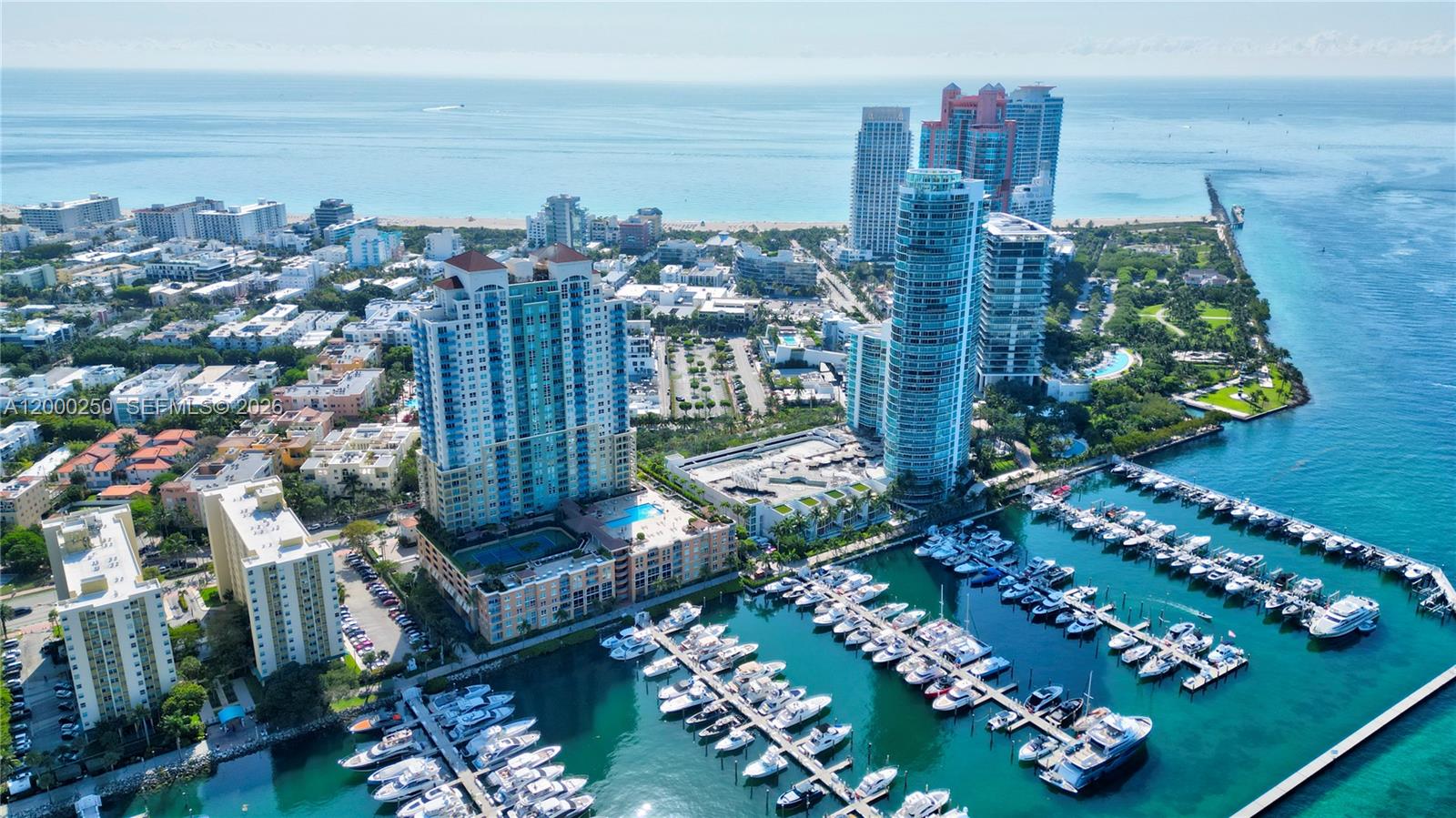 An aerial view shows high-rise apartment buildings, a marina filled with boats, and the ocean — 90 Alton Rd # 2010, Miami Beach FL 33139, MIAMI BEACH, FL