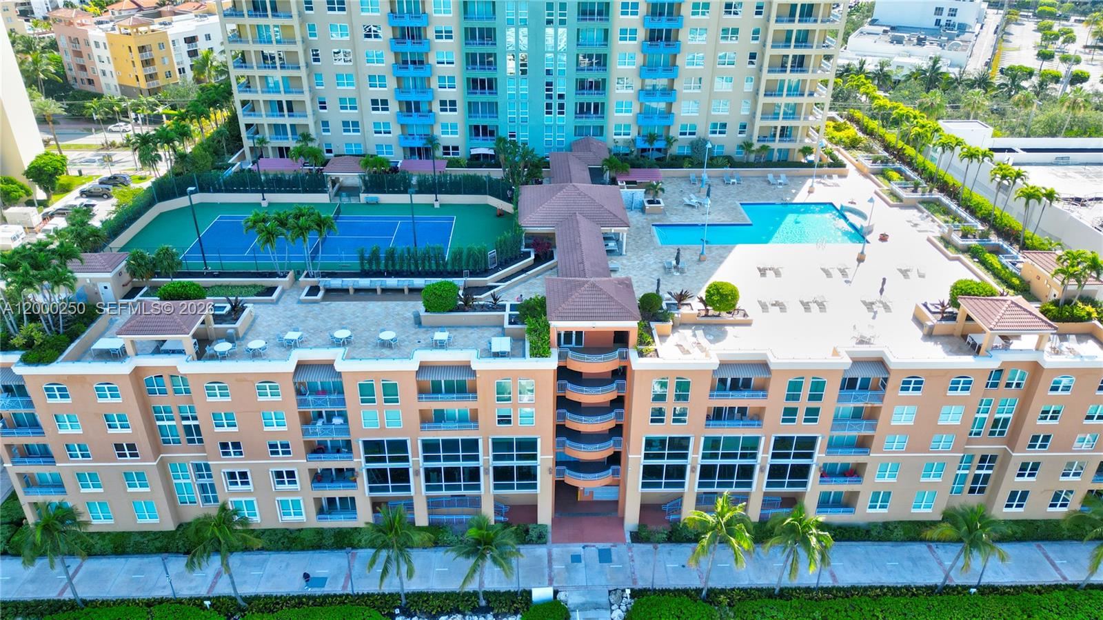 An aerial view shows a multi-story apartment building with a tennis court and swimming pool — 90 Alton Rd # 2010, Miami Beach FL 33139, MIAMI BEACH, FL