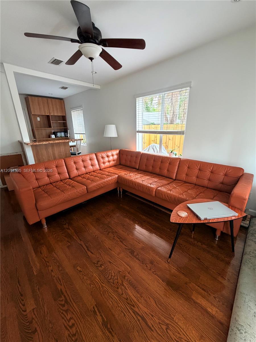 A living room features a large orange tufted sectional sofa on hardwood floors — 1918 Adams St Rear, Hollywood FL 33020, HOLLYWOOD, FL
