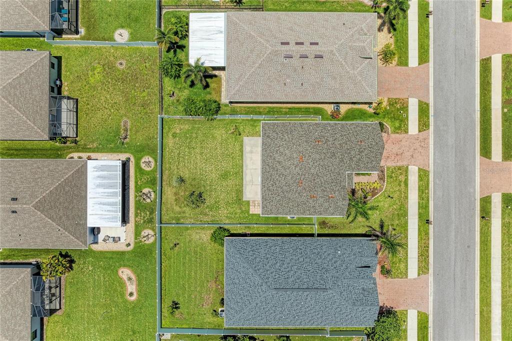 An aerial view shows several suburban houses with fenced backyards and paved driveways — 2084 LA PALMA AVENUE, PORT CHARLOTTE, FL
