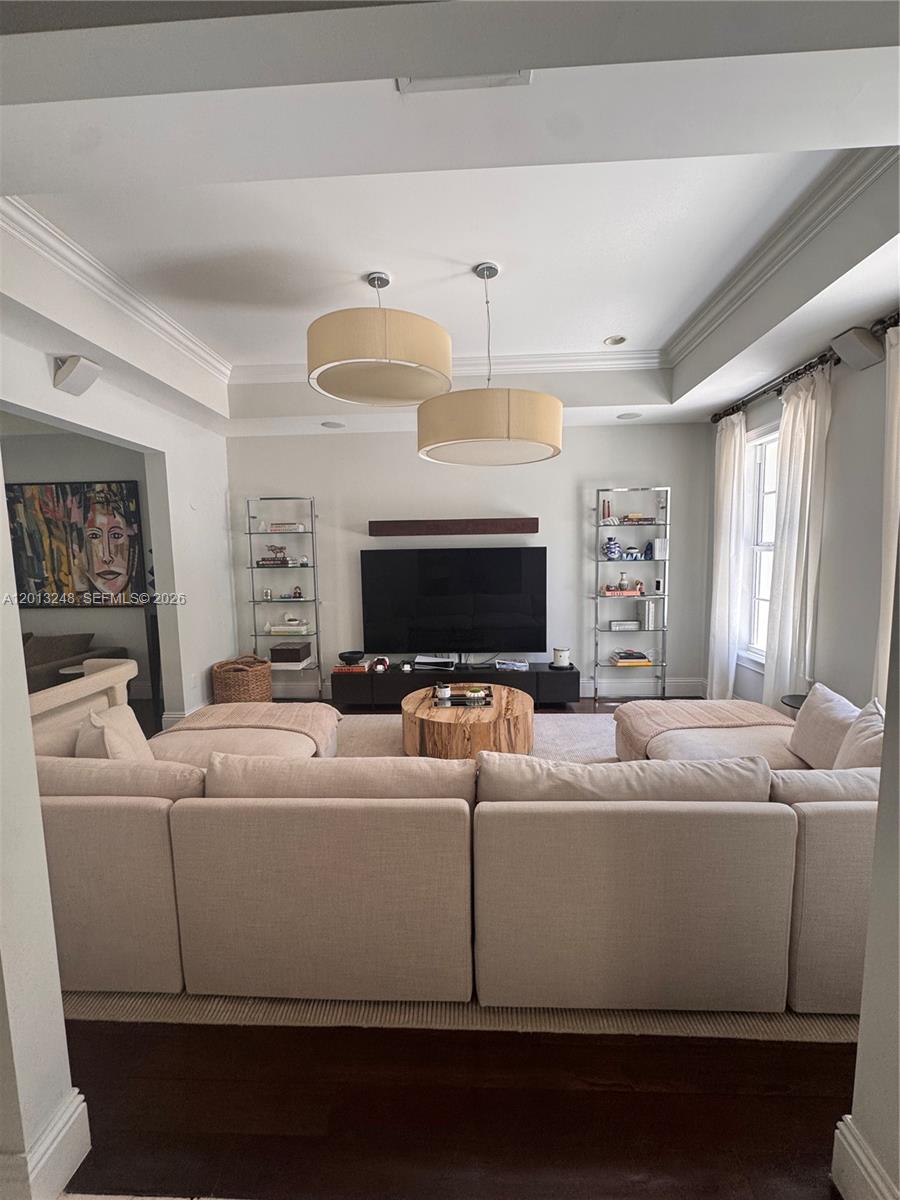 A living room features a large beige sectional, a wooden coffee table, and two pendant lights — 5000 SW 73rd Ter, Miami FL 33143, MIAMI, FL