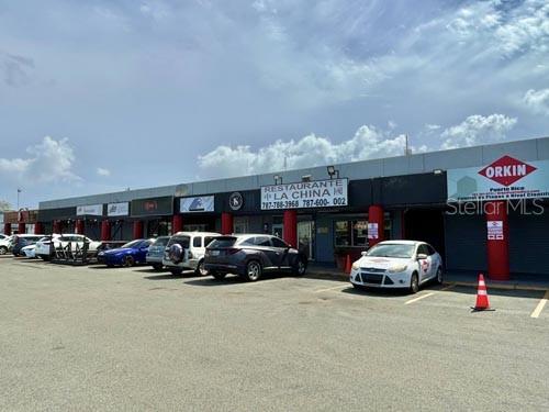 A commercial strip mall features a Chinese restaurant and parking lot under a blue sky — 1 BOULEVARD DE PALMAS, CATANO, PR