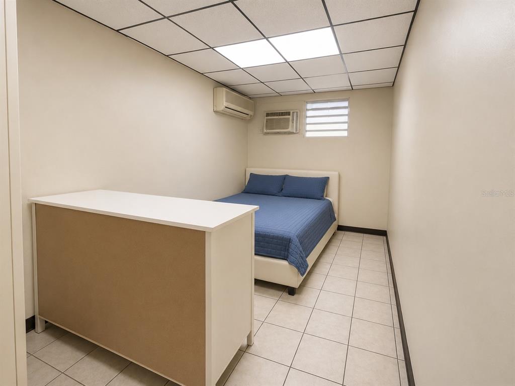 A bedroom with a bed, a white counter, tile flooring, and a drop ceiling — 1716 SAN ALFONSO, SAN JUAN, PR