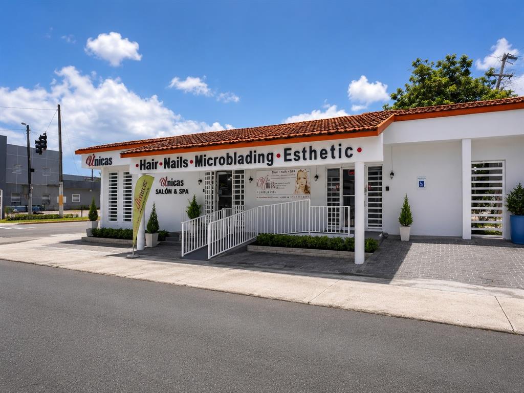 The exterior of a white commercial building features a red tile roof and a ramp — 1716 SAN ALFONSO, SAN JUAN, PR