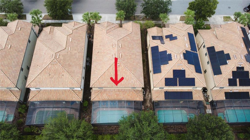 An aerial view shows a row of houses with tile roofs and screened-in swimming pools — 2183 TRIPOLI CT, KISSIMMEE, FL