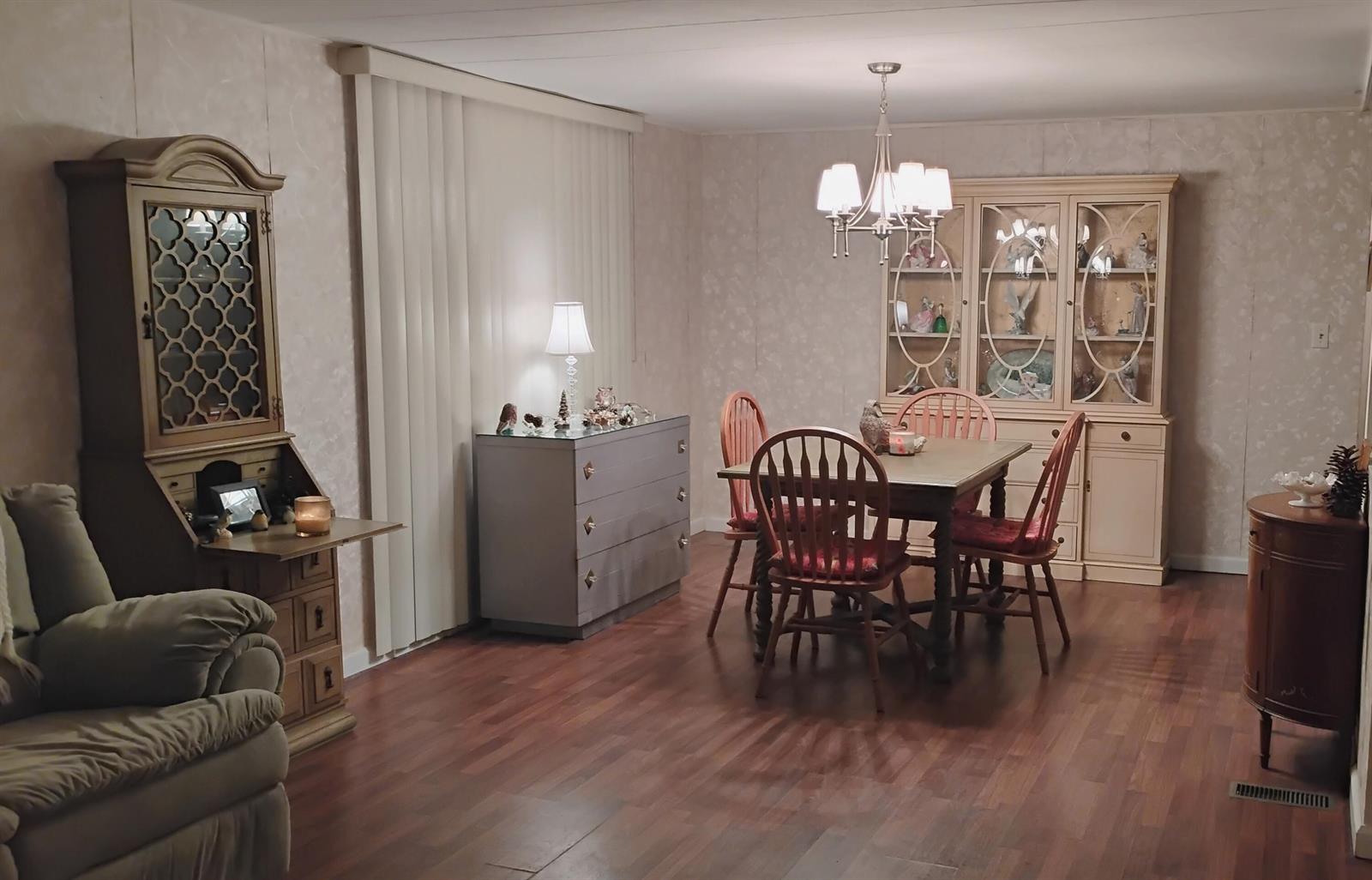 A dining room with wood flooring, a wooden table with chairs, and two large display cabinets — 20911 Sunrise Drive, Boca Raton FL 33433, BOCA RATON, FL