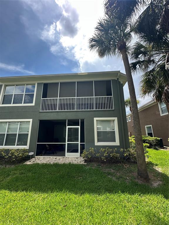 The exterior of a two-story building features a screened-in porch and a second-floor balcony — 2146 RIVER TURIA CIRCLE UNIT N/A, RIVERVIEW, FL