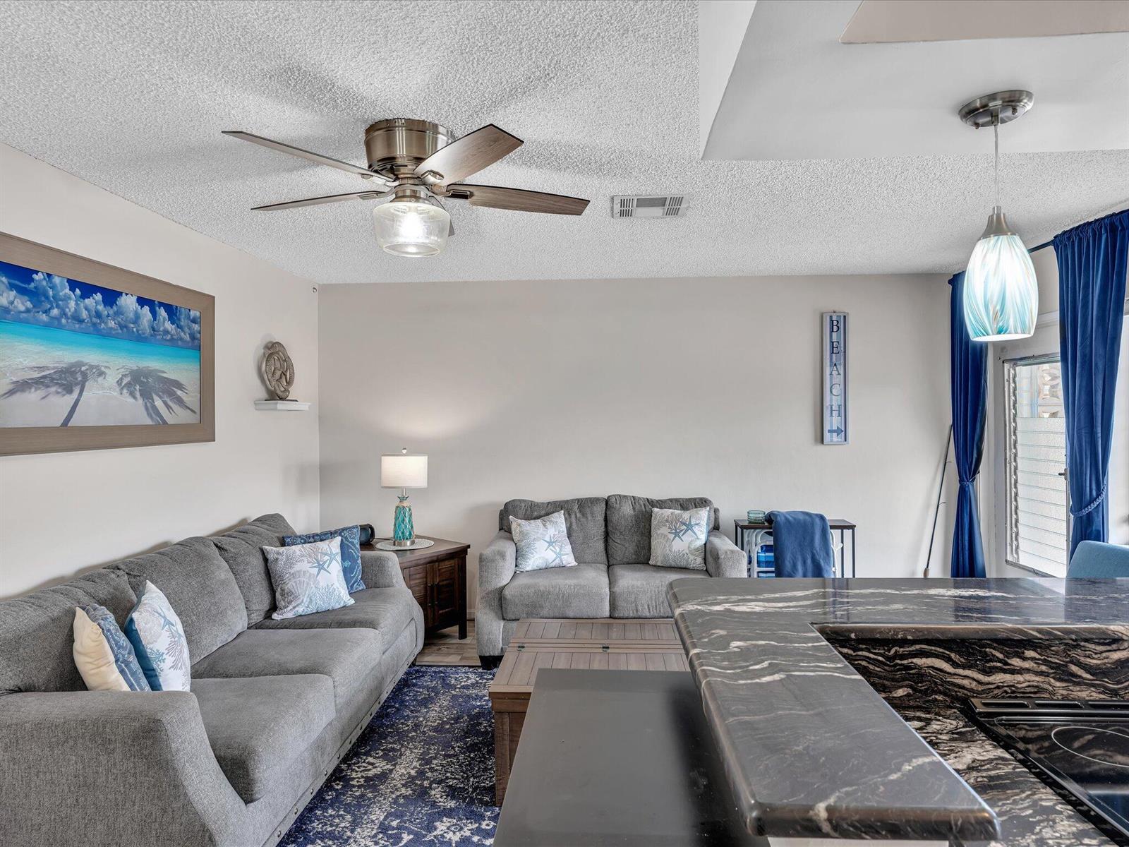 A living room features gray sofas, a dark blue area rug, and a kitchen island — 3232 Canal Drive # 19, Pompano Beach FL 33062, POMPANO BEACH, FL