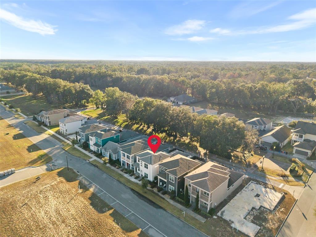 An aerial view shows a row of suburban houses with a red pin marking one — 6464 SW 77TH STREET, GAINESVILLE, FL