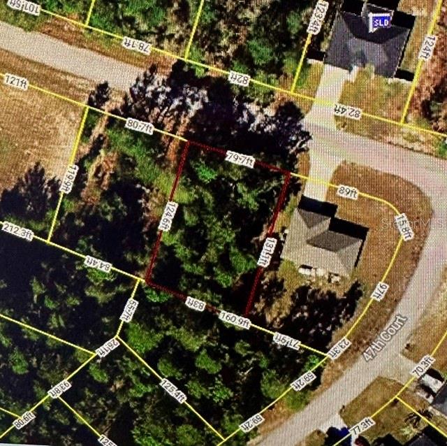 This is an aerial map showing a vacant residential lot outlined in red — SW 116TH LOOP, OCALA, FL