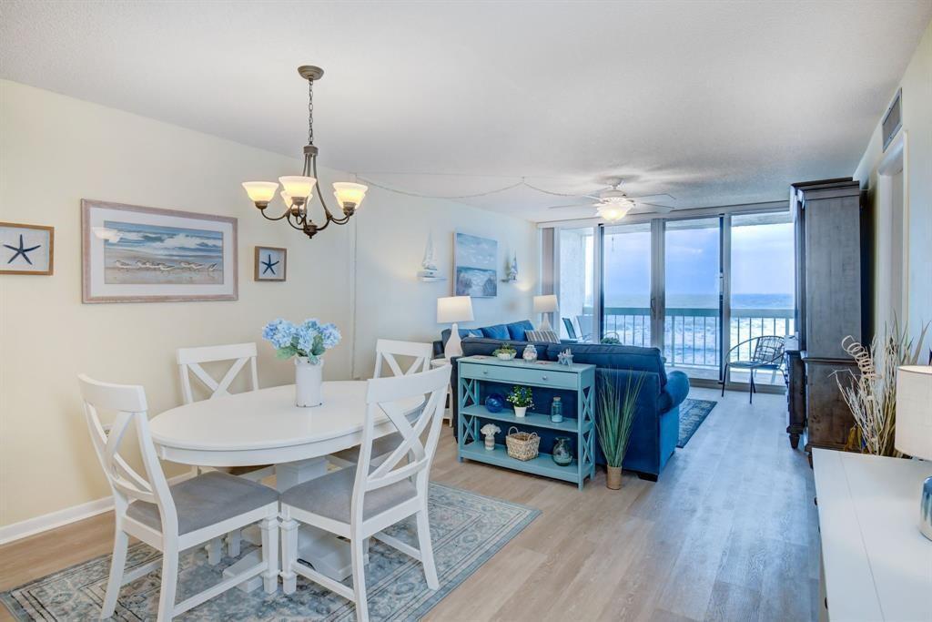 A dining area and living room with ocean views and coastal decor — 9940 S Ocean Drive # 505, Jensen Beach FL 34957, JENSEN BEACH, FL