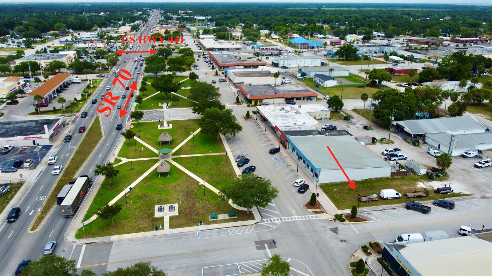 An aerial view shows a commercial area with a park, parking lots, and major roads — 320 SW Park Street, Okeechobee FL 34972, OKEECHOBEE, FL