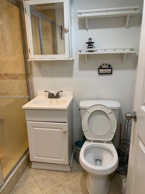 A kitchen with granite countertops and stainless steel appliances opens into a bedroom area — 6490 Collins Ave # 3, Miami Beach FL 33141, MIAMI BEACH, FL