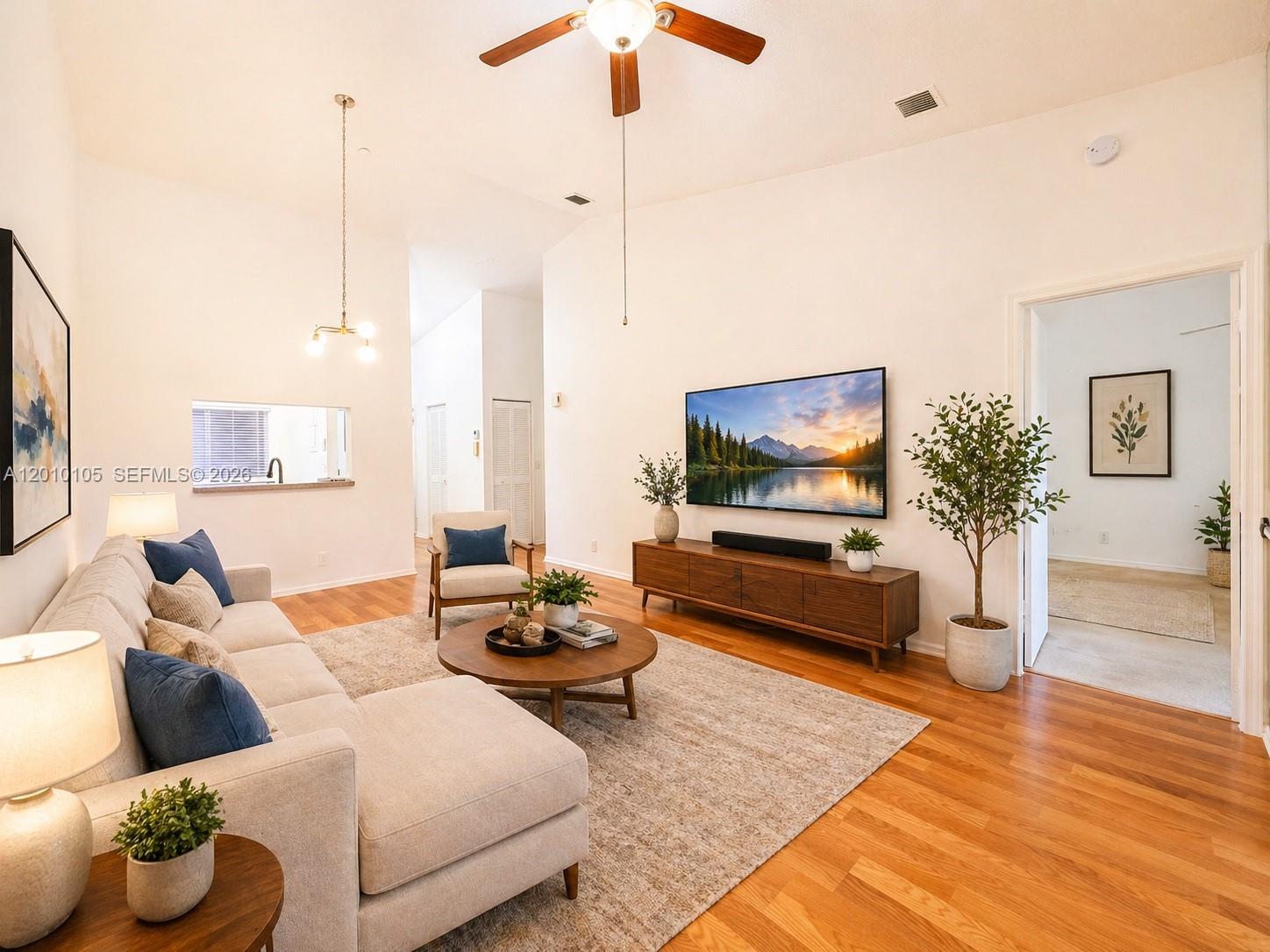A living room features a sectional sofa, a wooden media console, and a ceiling fan — 5016 Rose Hill Dr # 2303, Boynton Beach FL 33437, BOYNTON BEACH, FL