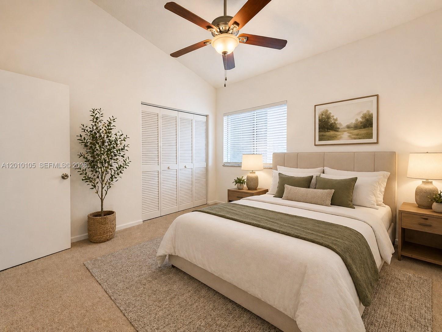 A bedroom features a queen bed, ceiling fan, closet with louvered doors, and neutral decor — 5016 Rose Hill Dr # 2303, Boynton Beach FL 33437, BOYNTON BEACH, FL