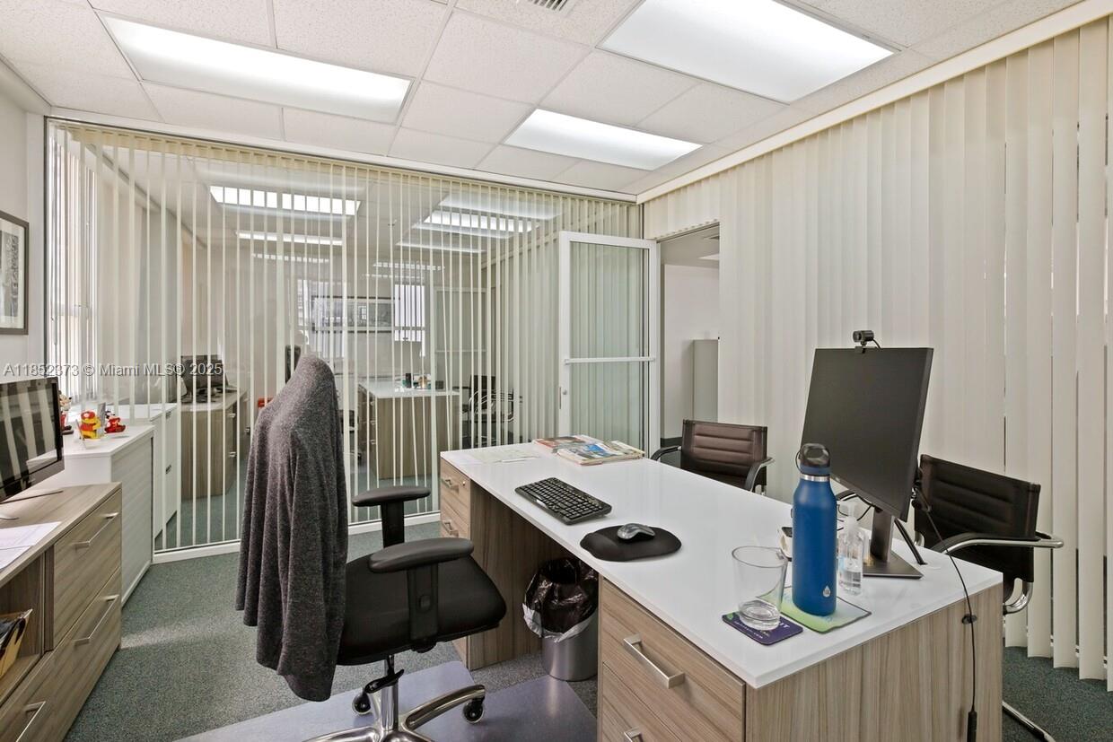An office with a white desk, black chairs, and glass-walled partitions — 168 SE 1st St # 9, Miami FL 33131, MIAMI, FL