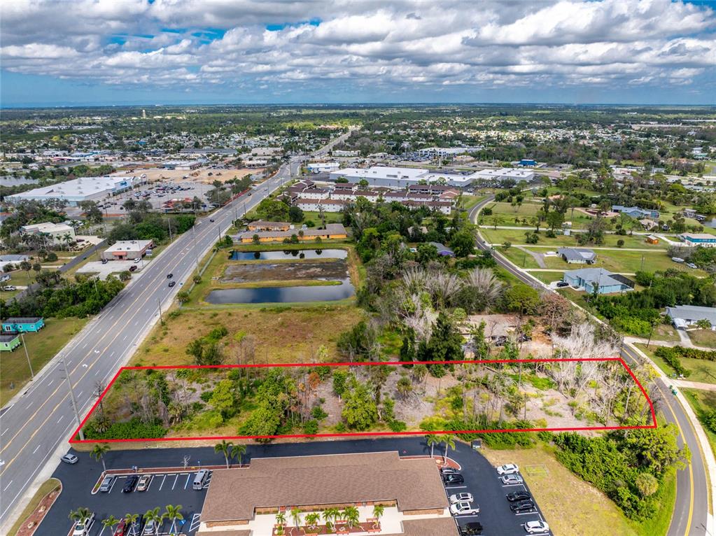 An aerial view shows a rectangular vacant lot outlined in red next to a road — 1781 PLACIDA ROAD, ENGLEWOOD, FL