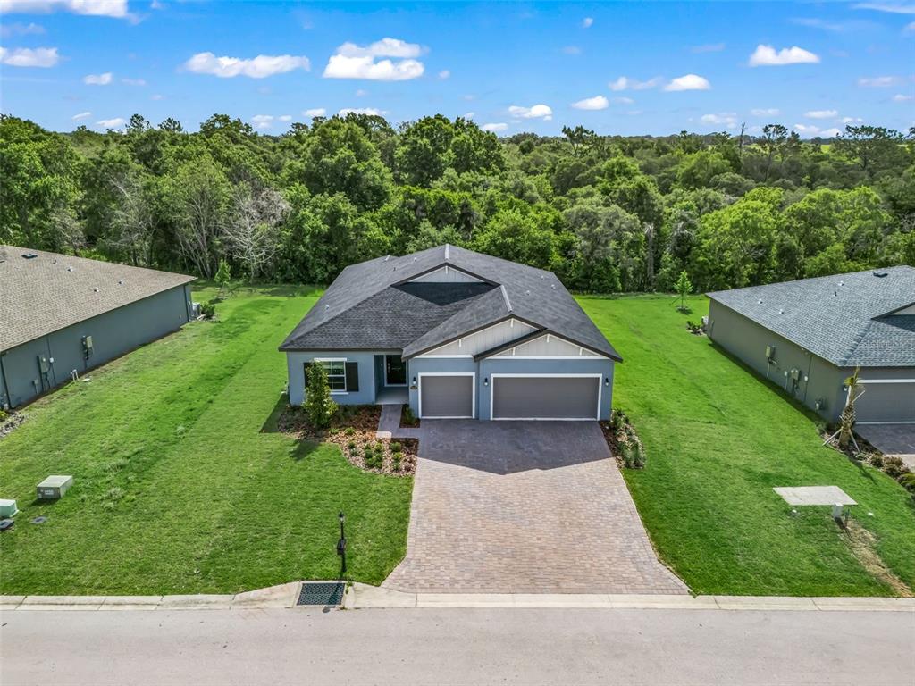 An aerial view of a single-story house with a three-car garage and paved driveway — 6510 SW 180TH CIRCLE, DUNNELLON, FL