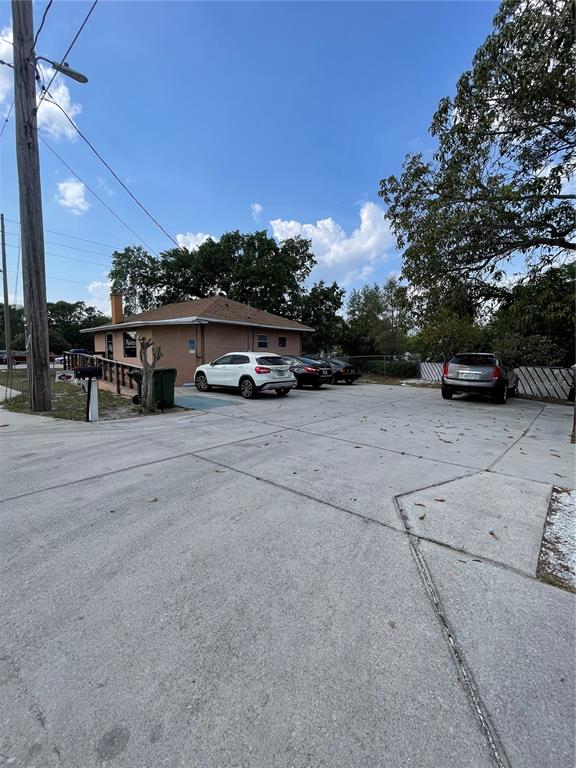 A small, tan commercial building with a parking lot and several parked cars — 2106 1ST STREET N, WINTER HAVEN, FL