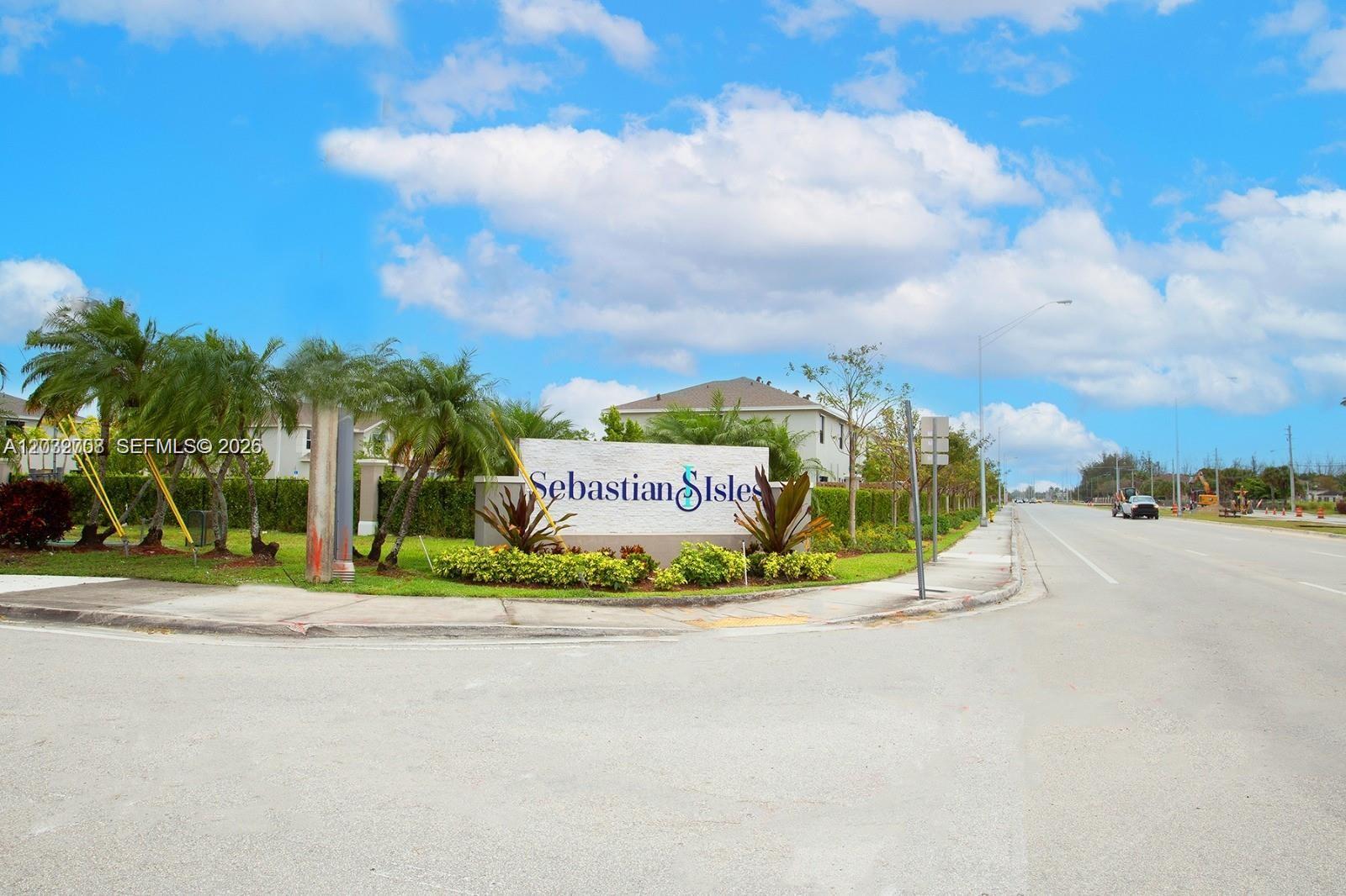 A stone monument sign for Sebastian Isles stands at a street corner with palm trees — 109 NE 3rd Ct, Florida City FL 33034, FLORIDA CITY, FL