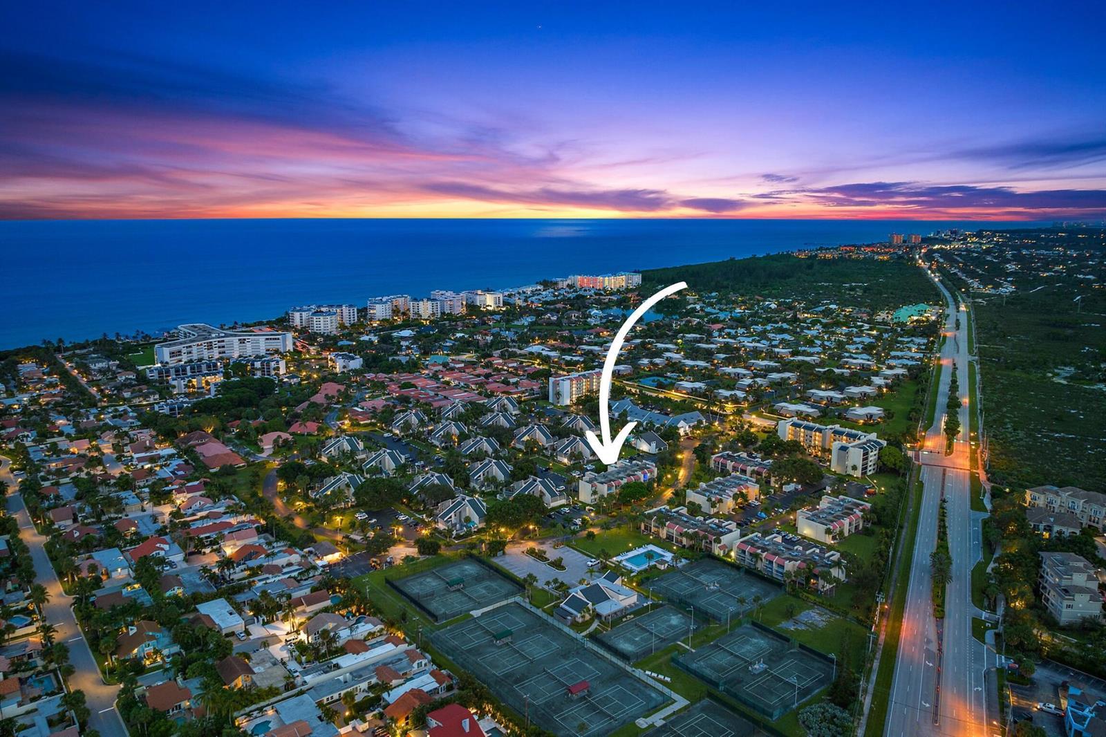 An aerial view of a residential community with a highlighted townhouse near tennis courts — 1605 S Us Highway 1 # 106, Jupiter FL 33477, JUPITER, FL