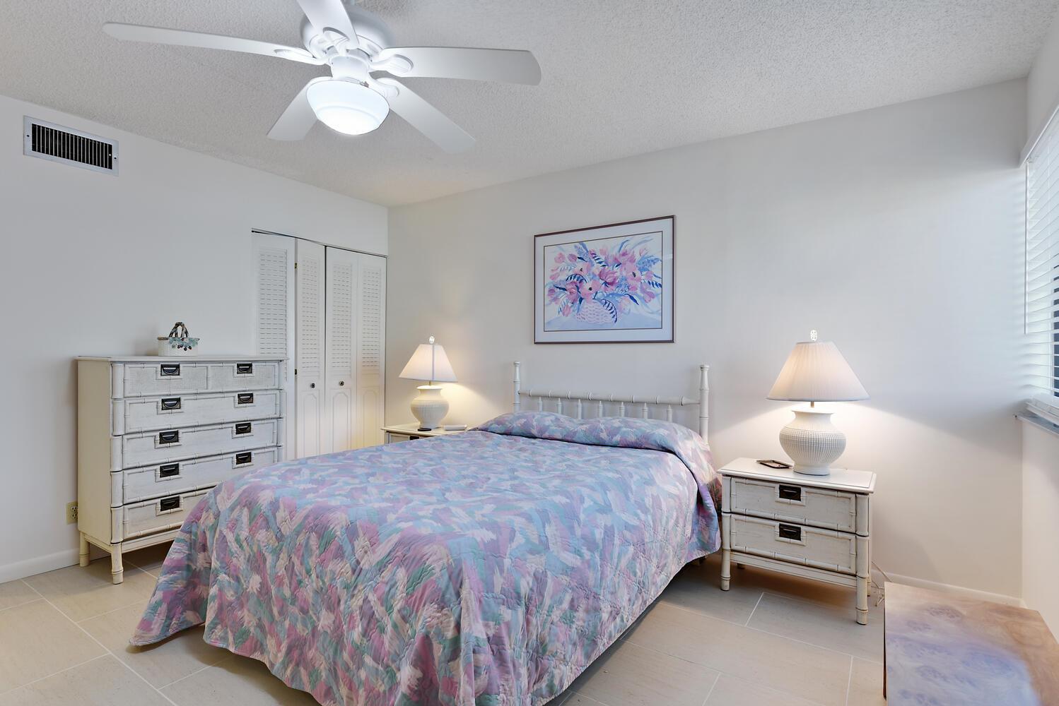 A bedroom with a bed, two nightstands, a dresser, and a ceiling fan — 1605 S Us Highway 1 # 106, Jupiter FL 33477, JUPITER, FL