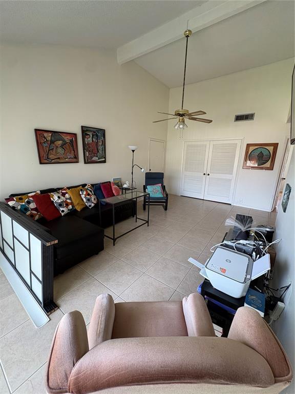 A living room features a black sectional sofa, a ceiling fan, and tile flooring — 436 WINDMEADOWS STREET UNIT 436, ALTAMONTE SPRINGS, FL