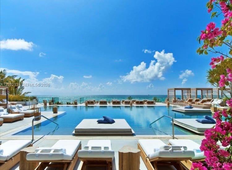 A swimming pool overlooks the ocean with lounge chairs and cabanas on the deck — 2301 Collins Ave # 843, Miami Beach FL 33139, MIAMI BEACH, FL