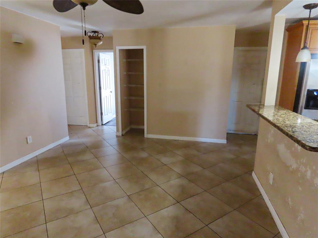 A tiled dining area features a ceiling fan, an open pantry, and a kitchen counter — 12909 123RD AVENUE, LARGO, FL
