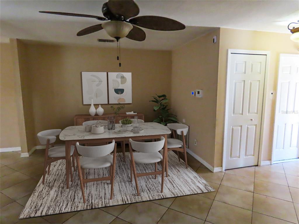 A dining area features a marble-topped table, six chairs, a rug, and a ceiling fan — 12909 123RD AVENUE, LARGO, FL