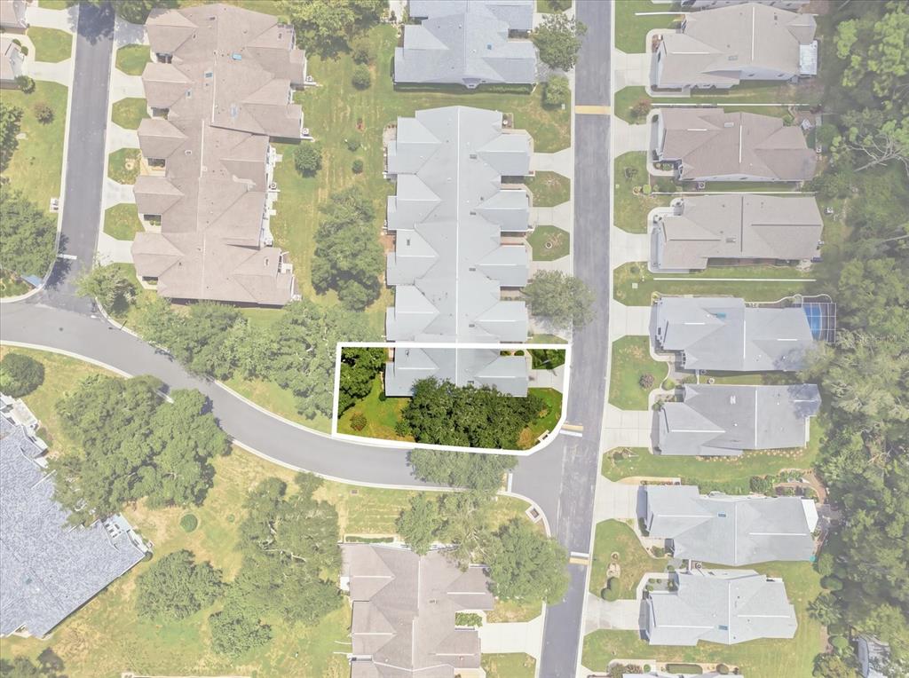 This aerial view shows a residential townhouse unit highlighted within a suburban neighborhood — 3540 S BELGRAVE DRIVE, INVERNESS, FL