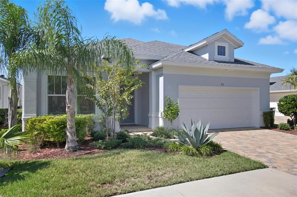 A single-story house with a gray exterior, a two-car garage, and a paved driveway — 21 SPRING STREET, PALM COAST, FL