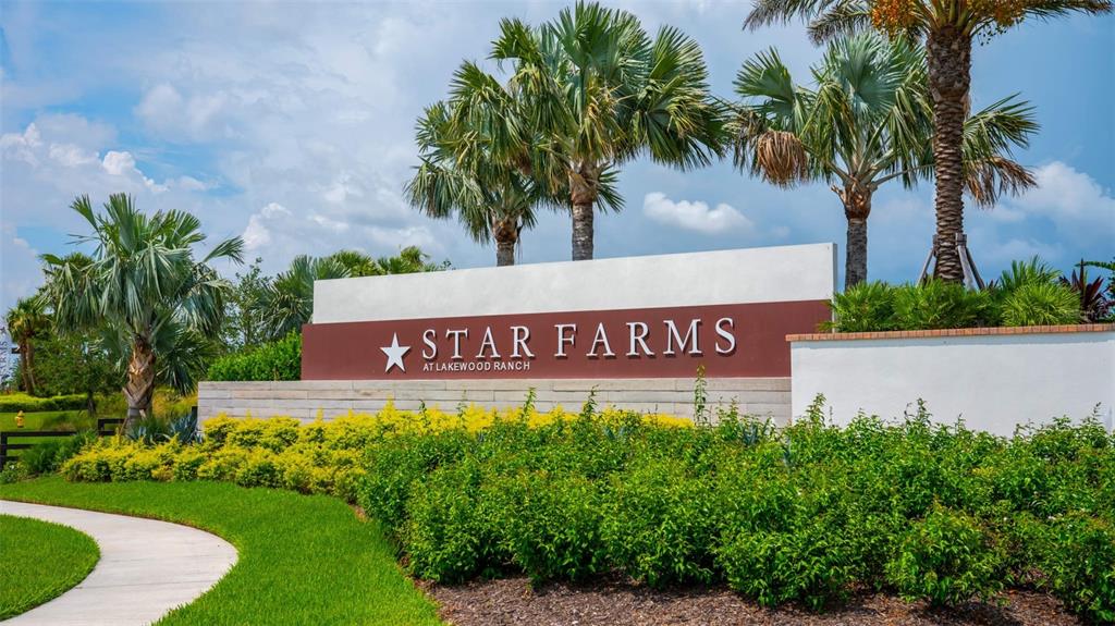 A sign for Star Farms at Lakewood Ranch stands behind a landscaped garden with palm trees — 3908 BUTTE TRAIL, BRADENTON, FL