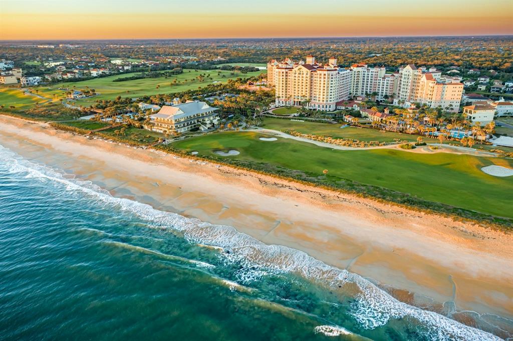 An aerial view of a large beachfront resort hotel situated next to a golf course — 21 NORTHSHORE DRIVE, PALM COAST, FL