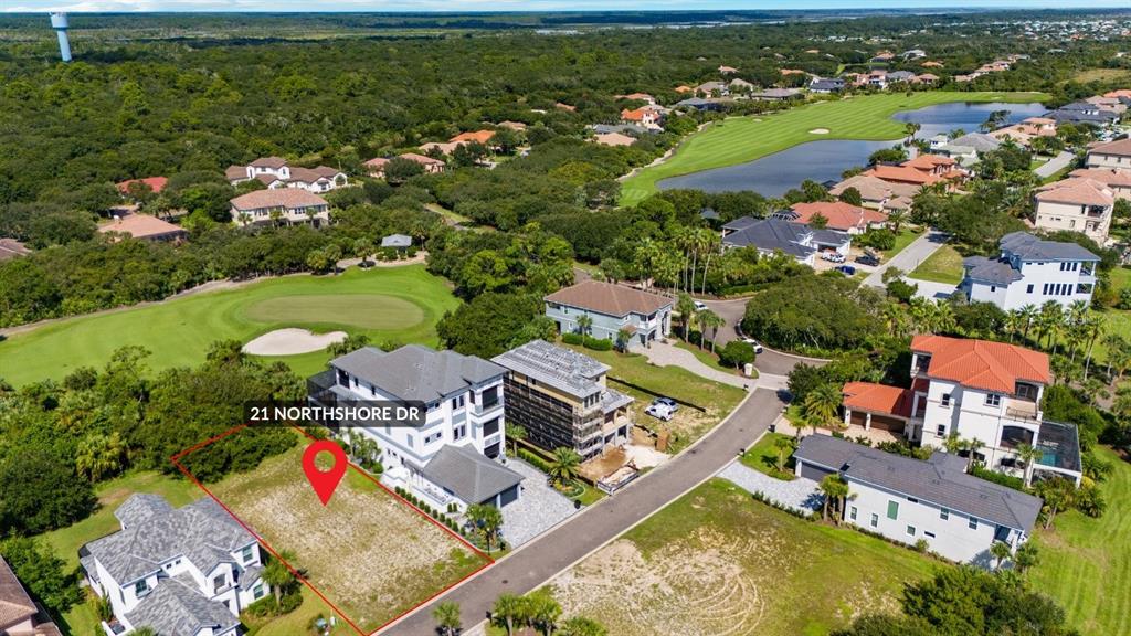 An aerial view shows a vacant residential lot outlined in red next to a house — 21 NORTHSHORE DRIVE, PALM COAST, FL