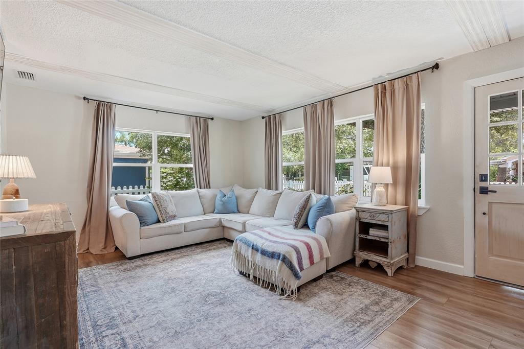 A living room features a sectional sofa, area rug, and windows with beige curtains — 3305 W BALLAST POINT BOULEVARD, TAMPA, FL