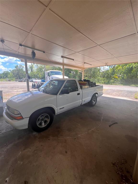 A white pickup truck is parked under a covered carport on a concrete slab — 3029 FORSYTH ROAD, WINTER PARK, FL