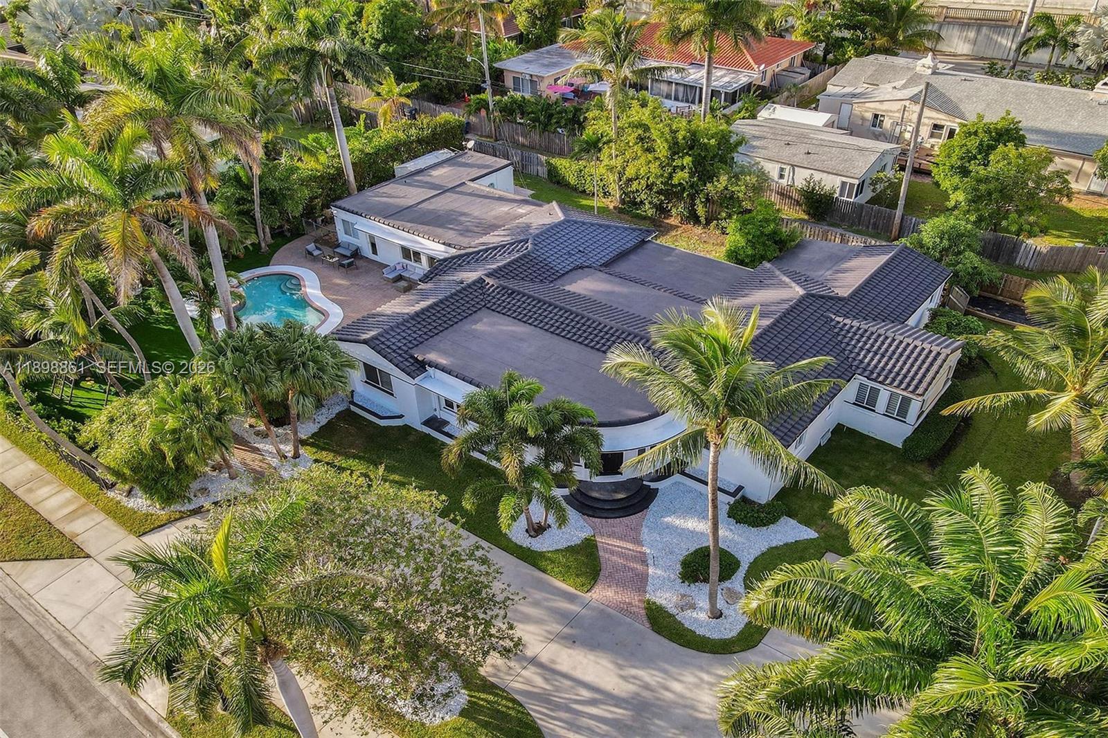 An aerial view of a white house with a dark tiled roof and a pool — 725 Harrison St, Hollywood FL 33019, HOLLYWOOD, FL