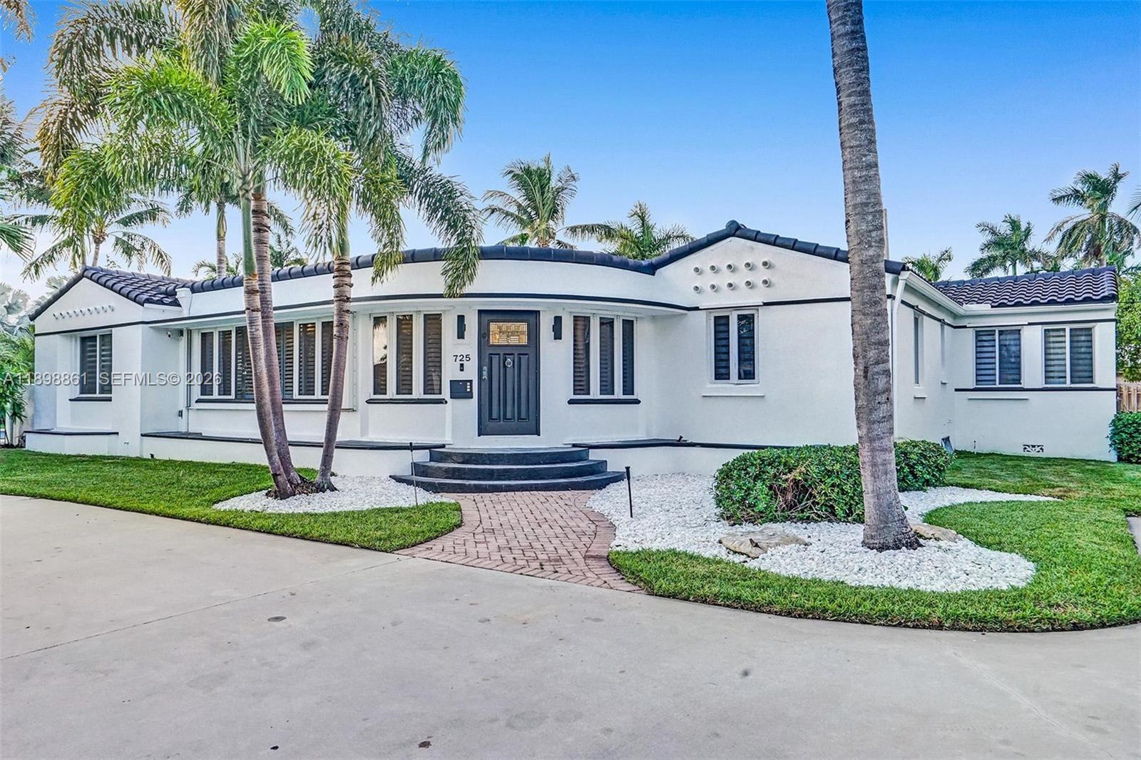 A white, single-story house with a curved facade, dark trim, and a tiled roof — 725 Harrison St, Hollywood FL 33019, HOLLYWOOD, FL