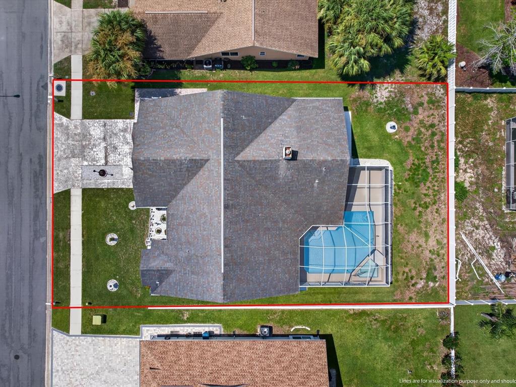 An aerial view of a residential property featuring a house with a pool and enclosure — 1197 MUSCOVY DR, SPRING HILL, FL