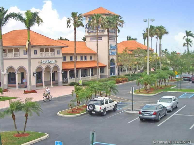 An exterior view of a commercial shopping center with a food court and parking lot — SW 396TH ST, Homestead FL 33035, HOMESTEAD, FL